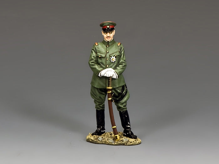 Figurine of a toy soldier military officer in green uniform with a gray background