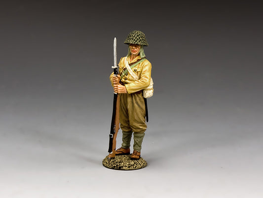 Toy soldier figure in military uniform with rifle on a gray background