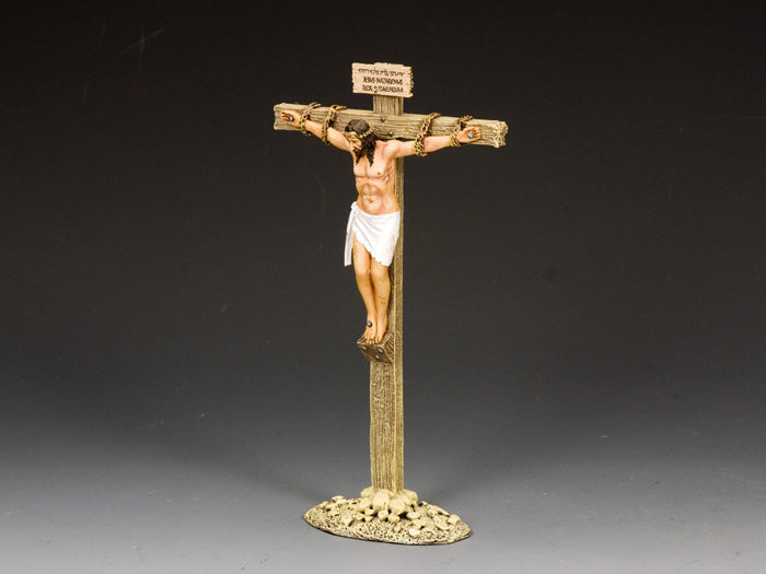 Statue of a crucified Jesus on a cross with a dark gray background