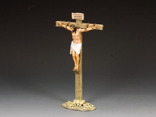 Statue of a crucified Jesus on a cross with a dark gray background