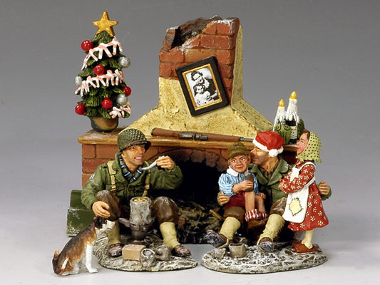 WWII figurine scene of two American GIs sharing a meal with Belgian children and a dog beside a ruined fireplace on Christmas Eve 1944.