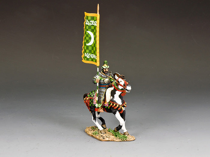 Saladin’s standard bearer in ornate armor on horseback, holding a green banner with crescent moon and script—symbol of Islamic unity.