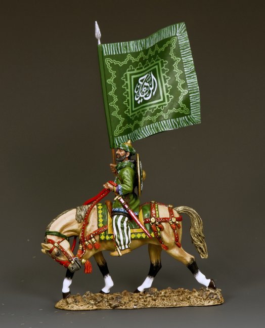 Model figure of a warrior on horseback holding a green flag with white text against a gray background