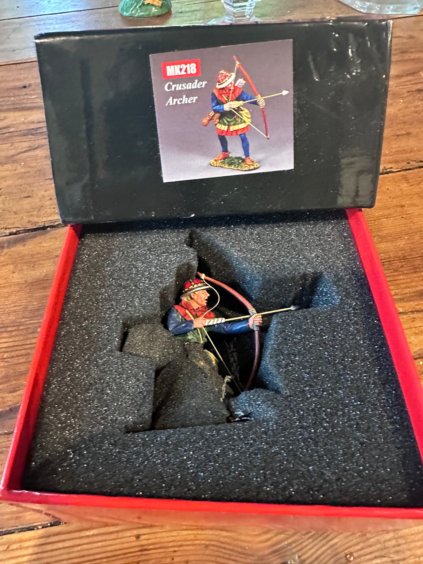 Toy soldier archer figure in a black foam-lined box.