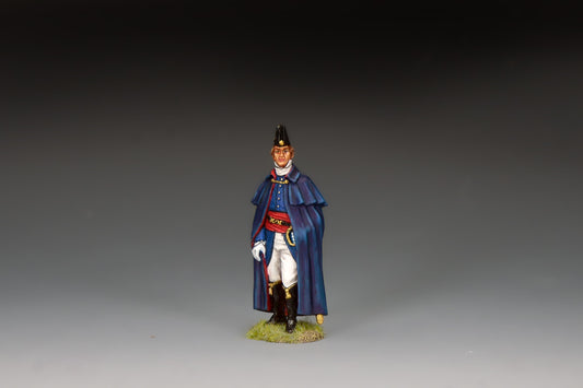 King & Country matte-painted metal figure of the Duke of Wellington standing in a dark blue caped cloak and black cocked hat, red sash, holding a riding crop, on a groundwork base.