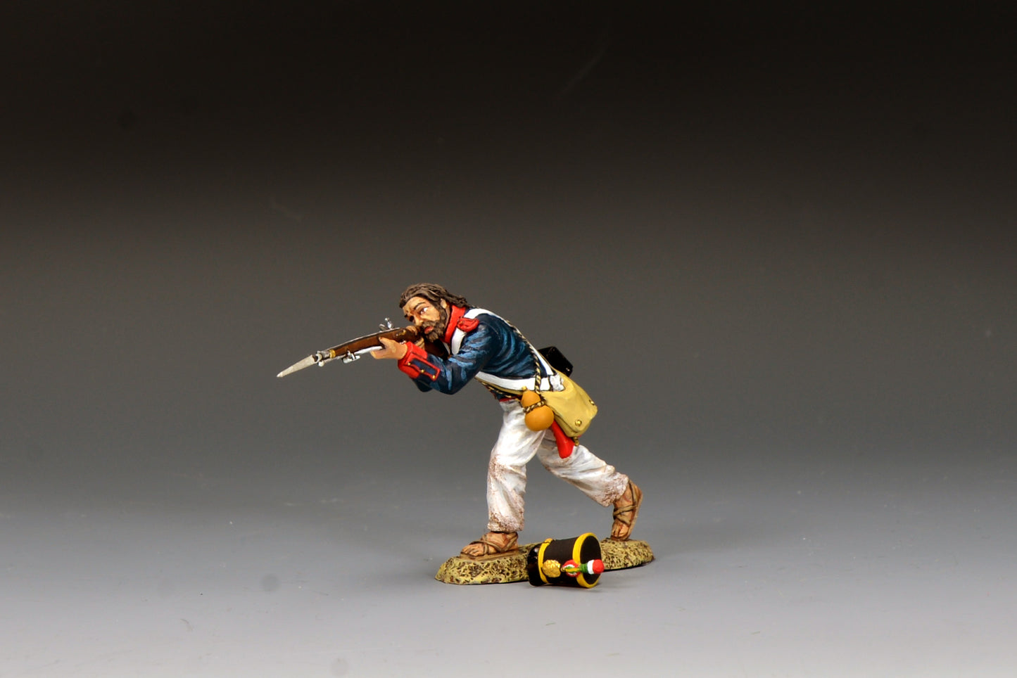 King & Country S.A.A. Soldier Advancing Firing, Mexican line infantryman firing bayoneted musket with shot-off shako on ground at his feet, blue coatee with red facings, Alamo 1836, 1/30 60mm matte figure, RTA142
