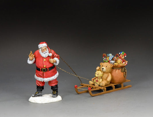 Santa Claus figurine pulling a toy-filled sled with teddy bears and a sack of gifts, hand-painted in matte finish.