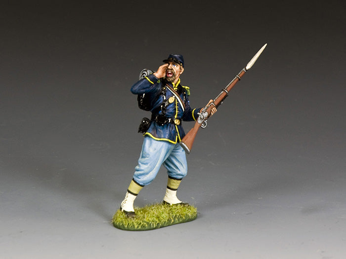 Military miniature Union corporal shouts a command over his shoulder while advancing with bayonet-fixed musket in hand.
