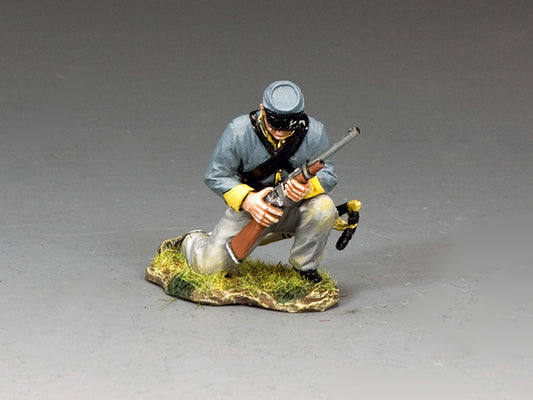 Toy soldier of a kneeling Confederate trooper cocking a carbine, dressed in gray and yellow uniform, ready to fire.