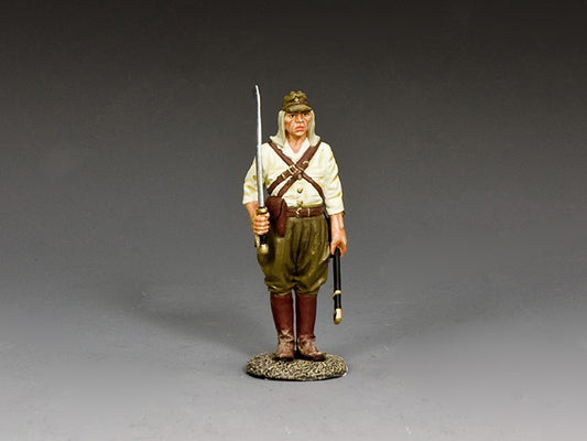 Japanese WWII sergeant stands holding unsheathed sword and scabbard, wearing tropical uniform, cap, and brown leather boots.