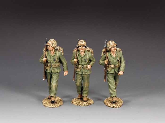 Three WWII U.S. Marine toy soldiers marching with rifles over shoulders. 1/30 scale, matte finish.