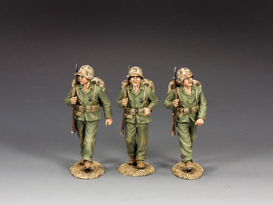 Three WWII U.S. Marine toy soldiers marching with rifles over shoulders. 1/30 scale, matte finish.