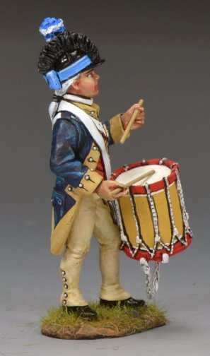 A painted toy soldier  figure of a historical soldier in uniform, playing a drum. The figure stands on a small grassy base and wears a dark blue coat, cream pants, and a tall hat with a blue plume.