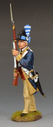 A painted military miniature figurine of a Revolutionary War soldier in blue and tan uniform holding a musket upright, standing on a small patch of grass against a plain gray background.