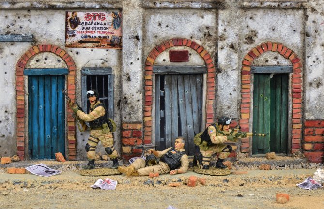Model diorama of a street scene Super six rescue set and a building facade.