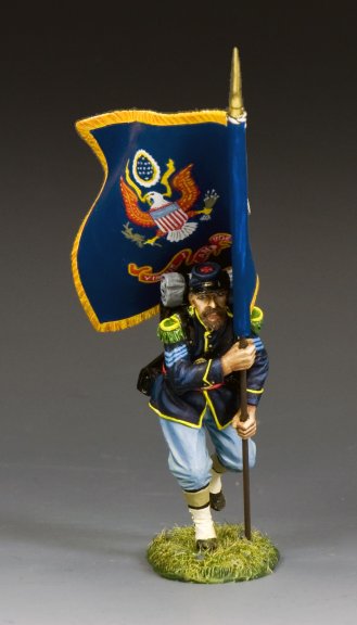 Military miniature Figurine of a soldier holding a flag with an emblem on a gray background