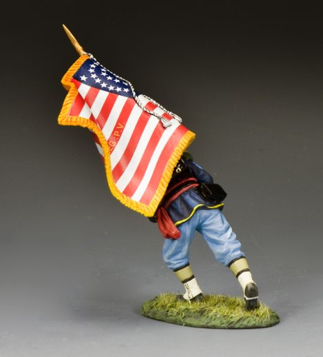 Military Miniature figure of a soldier holding an American flag on a gray background