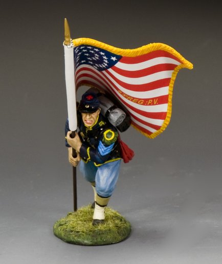Toy figure military miniature of a soldier holding an American flag on a gray background
