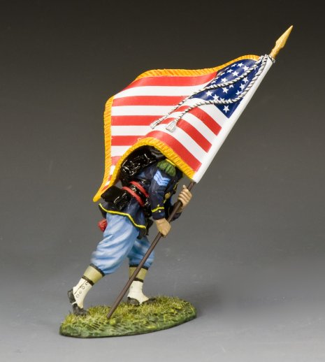 Toy figure of a soldier holding an American flag on a gray background