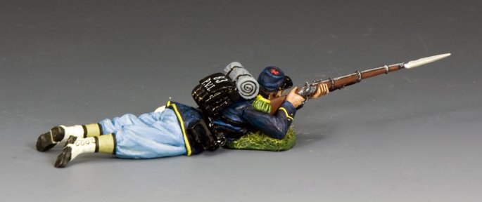 Lying Prone Firing. Military miniature in a prone position with a rifle on a gray background