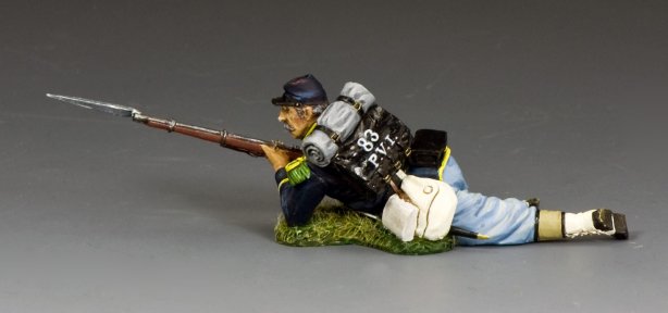 Toy soldier military miniature figure in a prone position with a rifle on a gray background