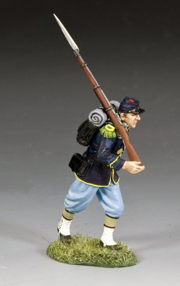 Model of a toy soldier in historical uniform with a rifle on a gray background