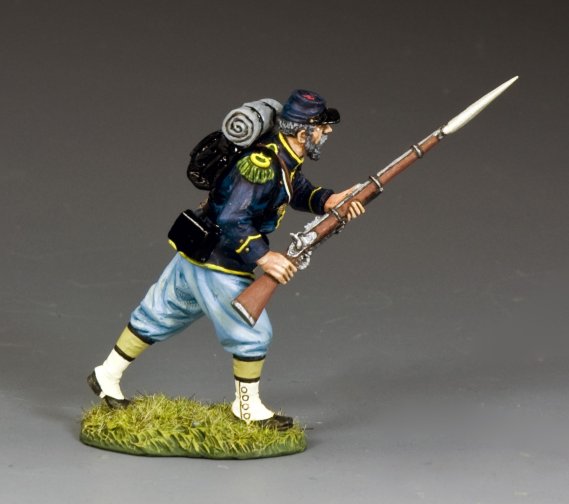 Painted military miniature figure of a soldier in historical uniform with a rifle on a gray background