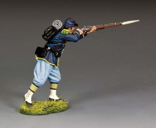 toy soldier Figurine Infantry Advancing Shooting of a soldier in blue uniform with a rifle on a gray background