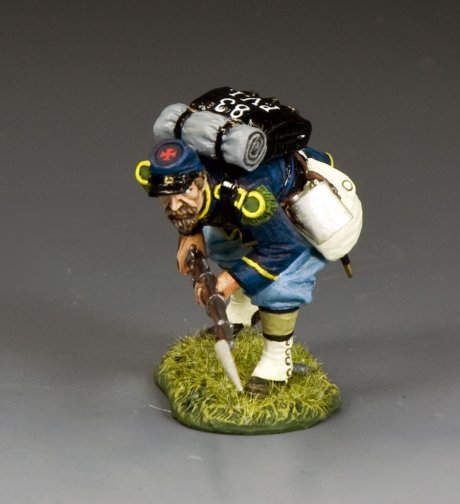 Toy figure Crouching Advancing of a character with a backpack and rifle on a gray background