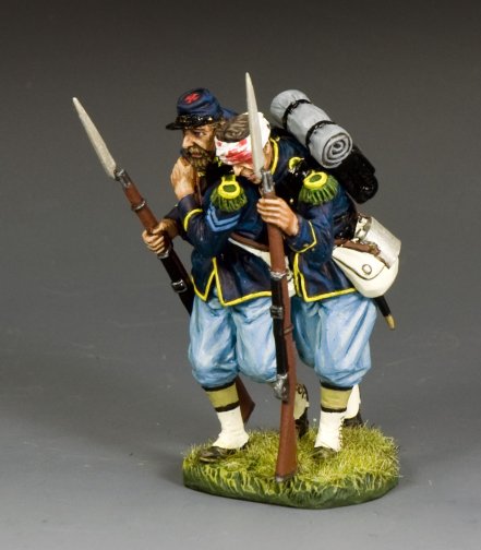 The Helping Wounded Painted miniature figure of a Civil War soldier holding rifles and a sword on a gray background