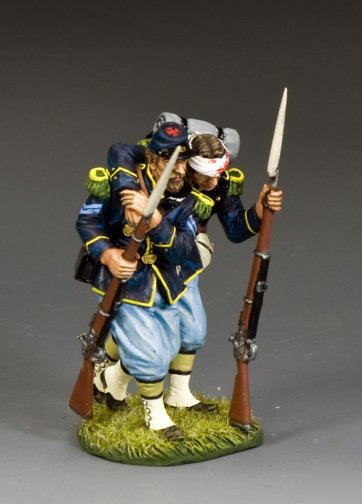 The Helping Wounded Model figure of a historical soldier with rifles and a bandaged head on a gray background