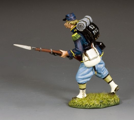 Toy soldier military miniature figure in Civil War uniform with rifle and backpack on a gray background