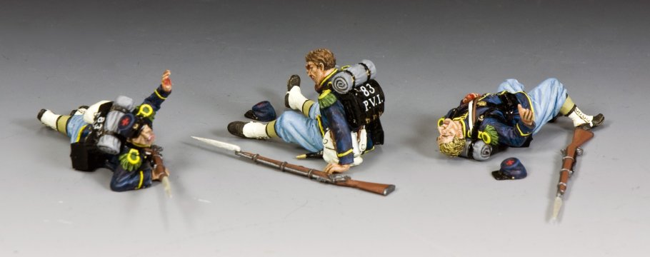 Three toy soldier Casualties of War in a prone position with rifles on a gray background