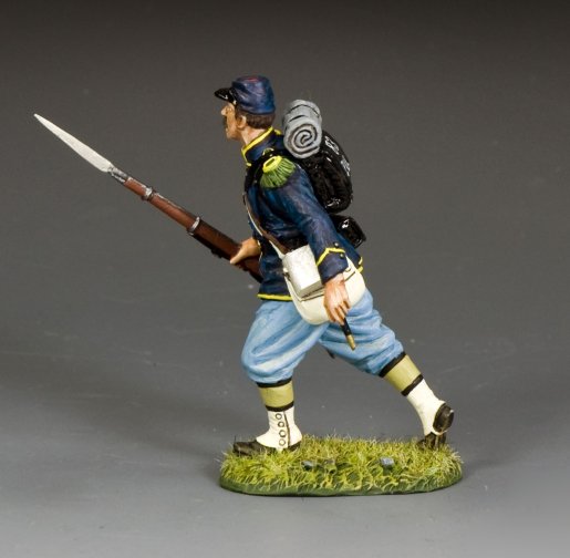 Model figure of a military miniature soldier in Civil War uniform with a rifle on a gray background