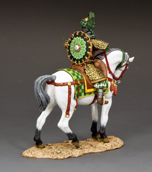 Decorative horse figurine with ornate saddle and green saddlecloth on a gray background Saladin the Mighty.
