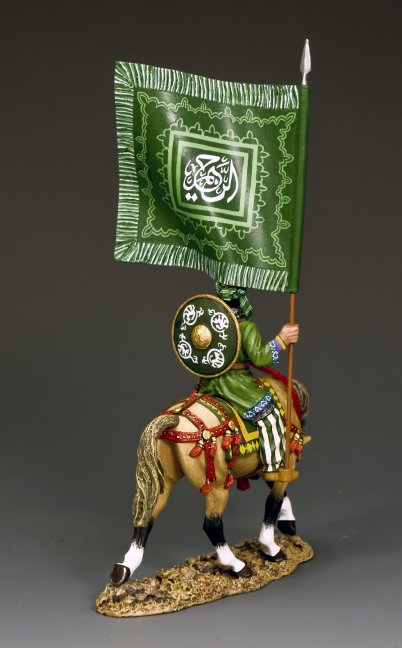 The Army of Islam Standard Bearer  on horseback carrying a large green flag with ornate Koranic script and Islamic geometric decoration. Rear view