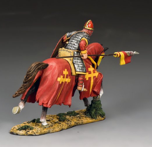 The Red Swabian Knight. Toy soldier Model of a warrior on horseback in red and gold armor with a flag, on a gray background