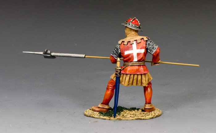 Crusader Halberdier. Toy Soldier Model of a medieval warrior in red armor with a spear on a gray background