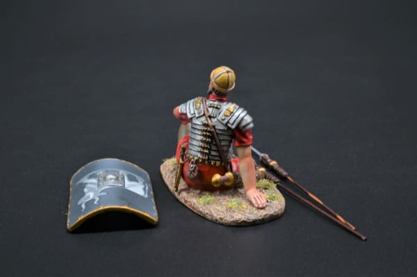 Collectible toy soldier miniature army men Resting Legionnaire. He has a shield and spears.