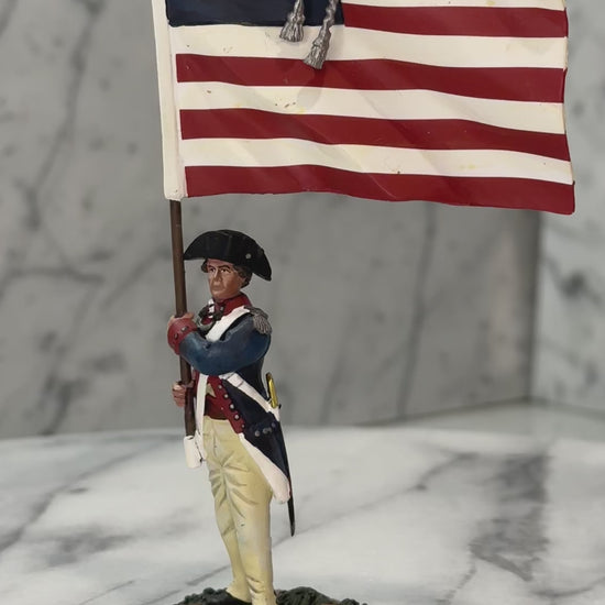 360 view of Collectible toy soldier miniature holding a U.S. Flag.