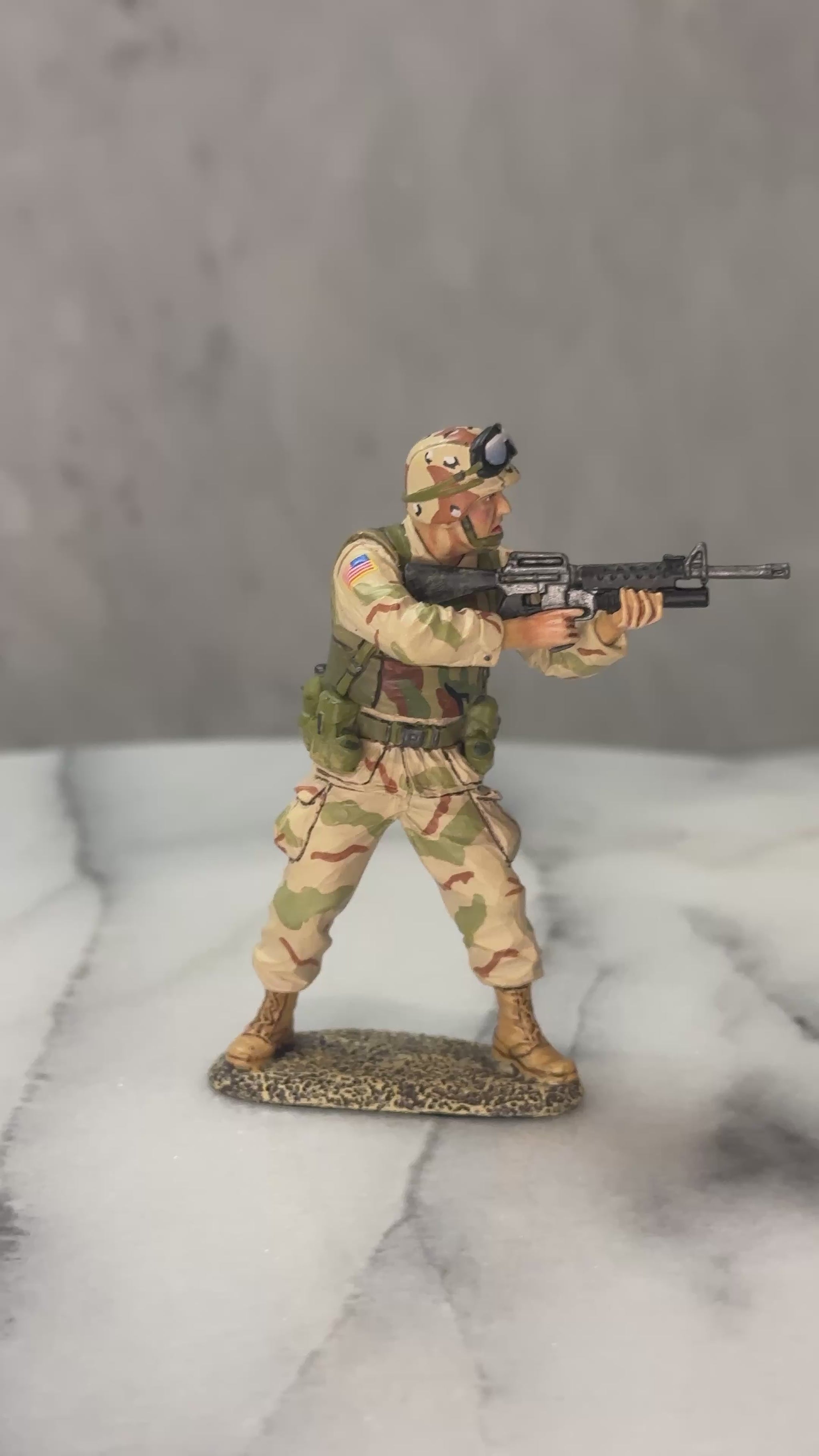 360 view of Toy Soldier U.S. Army Ranger aiming M16A2 with M203 grenade launcher in desert camo, mid-action.