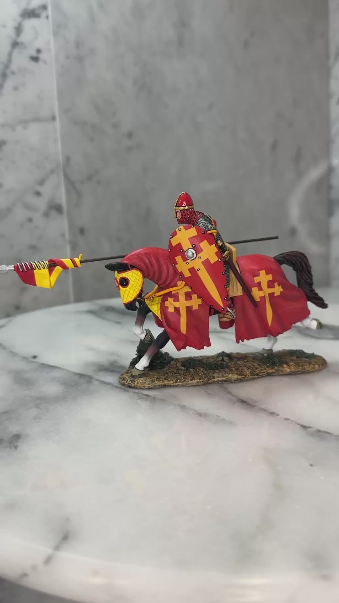 360 view of The Red Swabian Knight toy soldier on a marble surface.