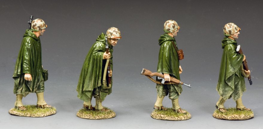 Four toy figures in green uniforms and raincoats with rifles on a gray background