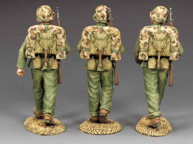 Three toy soldiers in camouflage uniforms on a gray background