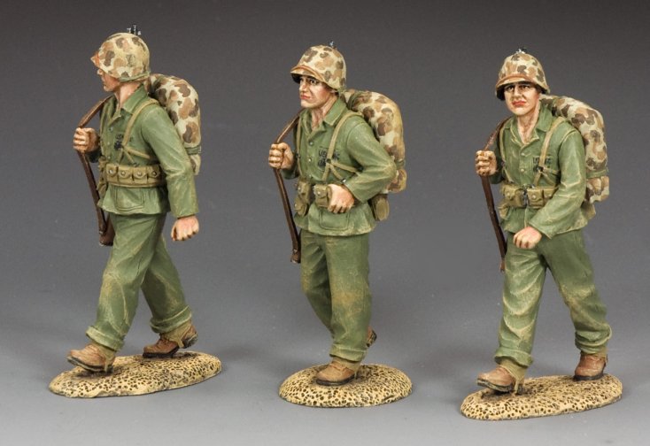 Three WWII U.S. Marine military miniatures marching with rifles over shoulders. 1/30 scale, matte finish.