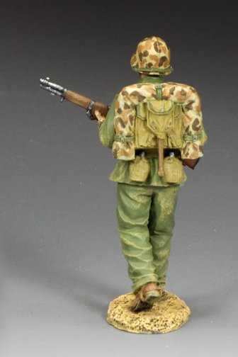 Walking Marine. Model of a soldier in camouflage uniform with a rifle on a gray background
