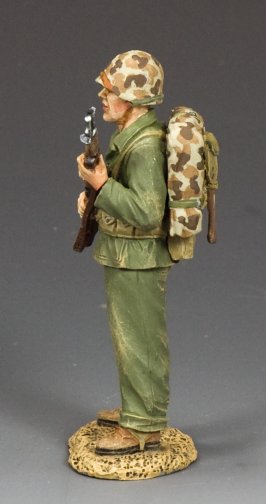 Standing Ready Marine. Model of a soldier in military uniform with backpack and rifle on a gray background