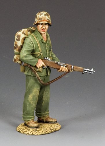Watching Marine. Model of a soldier in green uniform with a rifle and backpack on a gray background