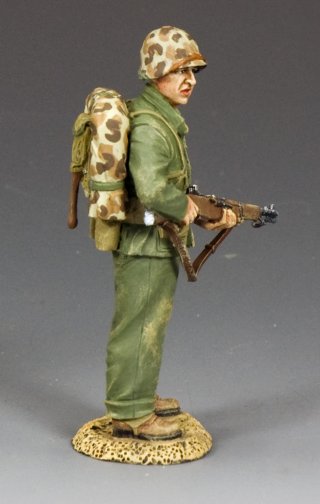 Watching Marine. Military miniature model in green uniform with a backpack and rifle on a gray background