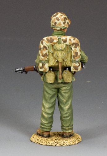 Watching Marine. Toy soldier in camouflage uniform with backpack and rifle on a gray background